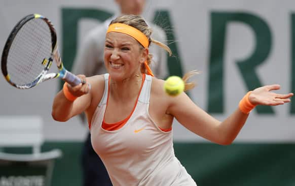 Belarus` Victoria Azarenka returns the ball to France`s Alize Cornet during their third round match of the French Open tennis tournament at the Roland Garros stadium in Paris.