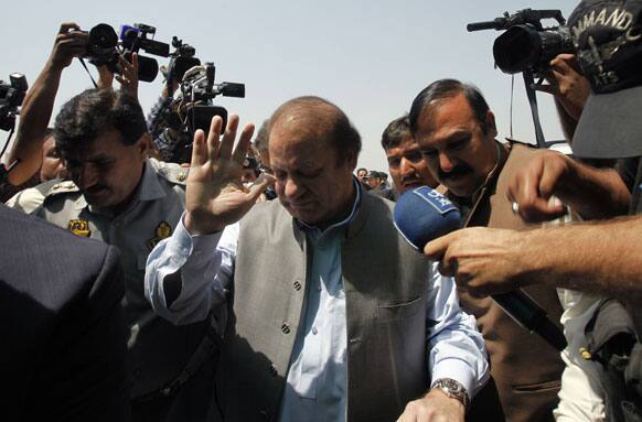 Pakistan`s incoming prime minister, Nawaz Sharif, center, surround by media persons, arrives to attend the first National Assembly session in Islamabad.