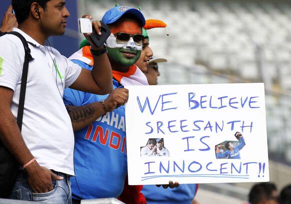 A cricket supporter displays a placard, prior to the start of the ICC Champions Trophy warm-up cricket match between India and Sri Lanka, at Edgbaston cricket ground in Birmingham, England.