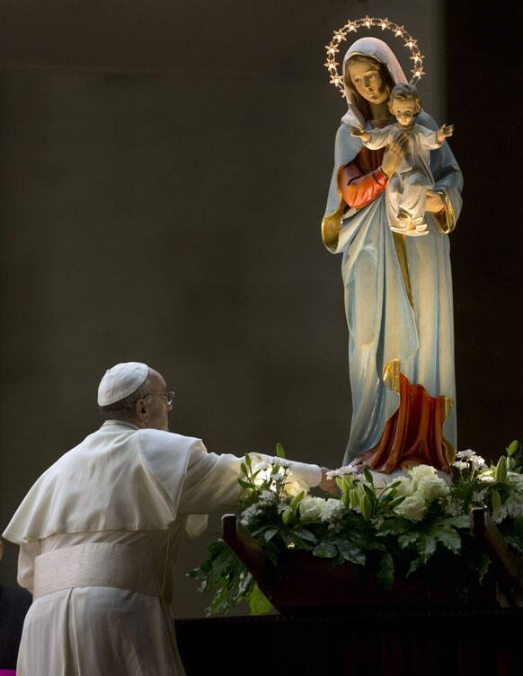 Pope Francis pays homage to a statue of the Virgin Mary during a ceremony to mark the closure of the month dedicated to the Virgin Mary, in St. Peter`s Square, at the Vatican.