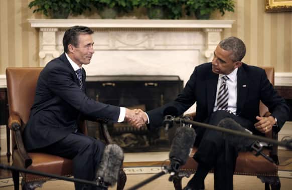 President Barack Obama shakes hands with NATO Secretary General Anders Fogh Rasmussen during their meeting in the Oval Office of the White House in Washington.
