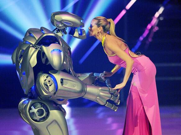 Jury member and casting show host Heidi Klum stands on stage with an actor dressed in a robot costume during the final show of the German television model casting show `Germany`s Next Topmodel` at the SAP-Arena in Mannheim, Germany.