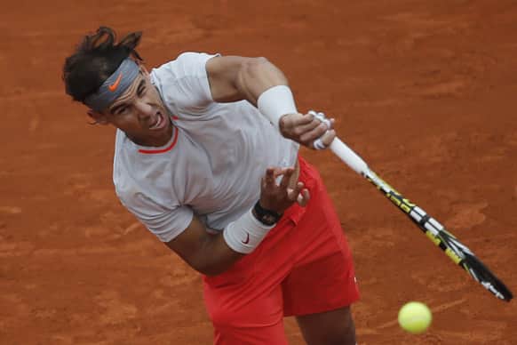 Rafael Nadal of Spain serves against Slovakia`s Martin Klizan in their second round match at the French Open tennis tournament, at Roland Garros stadium in Paris.