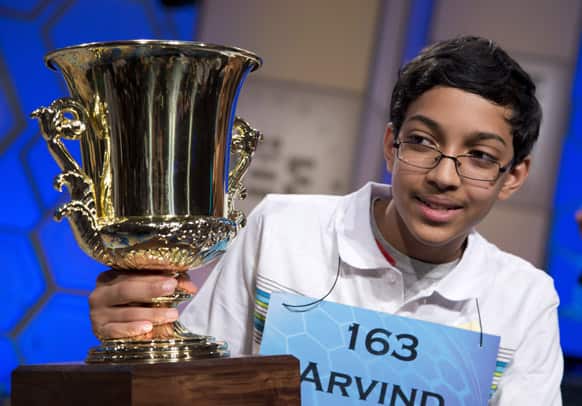Arvind Mahankali, 13, of Bayside Hills, N.Y., holds the championship trophy after he won the National Spelling Bee by spelling the word