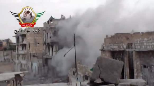 This image made from video posted by Shaam News Network, which is consistent with other AP reporting, shows an explosion from shelling in Rastan, Syria.
