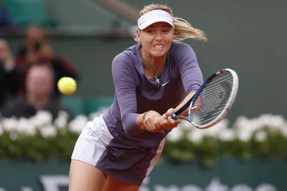 Russia`s Maria Sharapova returns against Canada`s Eugenie Bouchard in their second round match at the French Open tennis tournament, at Roland Garros stadium in Paris.