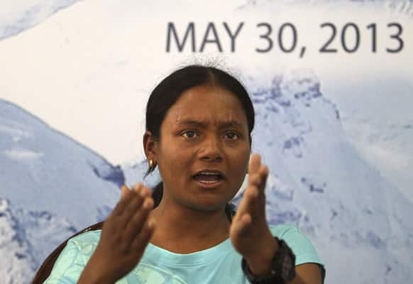 Arunima Sinha, who became India’s first amputee woman to conquer Mount Everest on a prosthetic leg on May 21, 2013, gestures during a press conference in New Delhi.