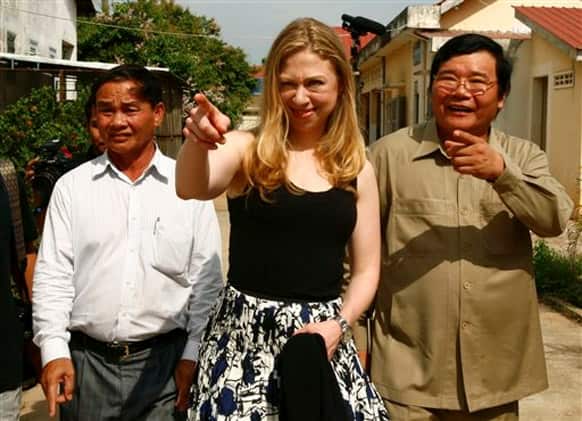 Chelsea Clinton, daughter of former US President Bill Clinton, gestures as she tours with Cambodian Dr. Mean Chhi Von, director of the National Center of HIV/AIDS, in Neak Loeung town, Prey Veng province.