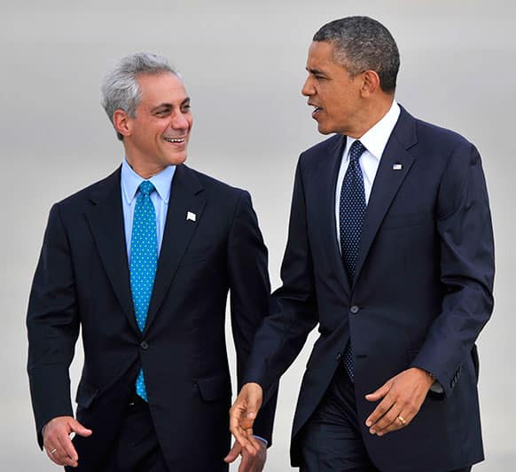 President Barack Obama right, talks with Chicago Mayor Rahm Emanuel left, as he walks off Air Force One after arriving at O`Hare International Airport in Chicago.