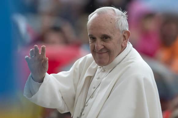 Pope Francis waves as he leaves at the end of his weekly general audience, in St. Peter`s Square, at the Vatican.