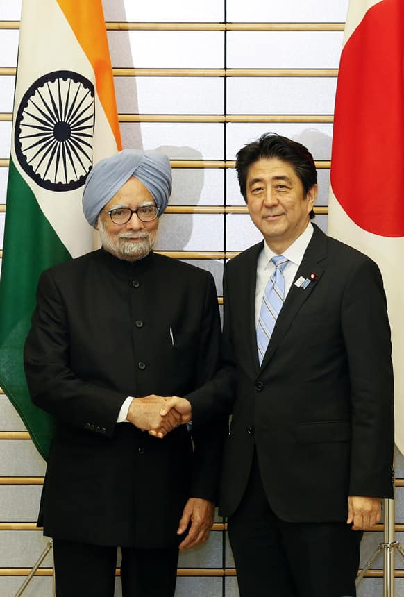 Prime Minister Manmohan Singh, left, shakes hands with his Japanese counterpart Shinzo Abe at the start of talks at the latter`s official residence in Tokyo.