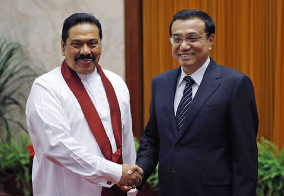 Sri Lanka`s President Mahinda Rajapaksa, shakes hands with China`s Premier Li Keqiang at the Great Hall of the People in Beijing.