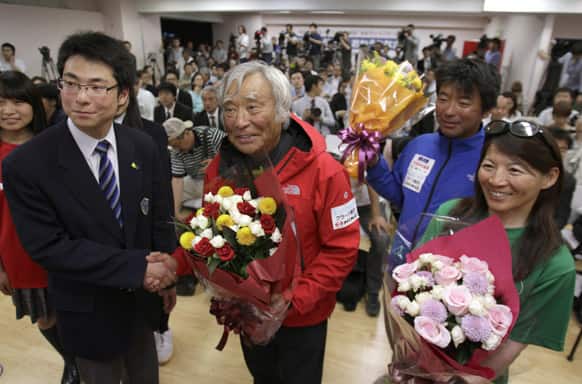 Yuichiro Miura, an 80-year-old Japanese mountaineer who became the oldest person to reach the top of Mount Everest last Thursday, poses for photographers before speaking at a press conference at CLARK Memorial International High School in Tokyo.