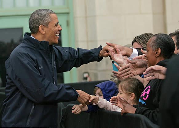 President Barack Obama meets people who waited in the rain to see him by the Asbury Park Convention Hall in Asbury Park, N.J.