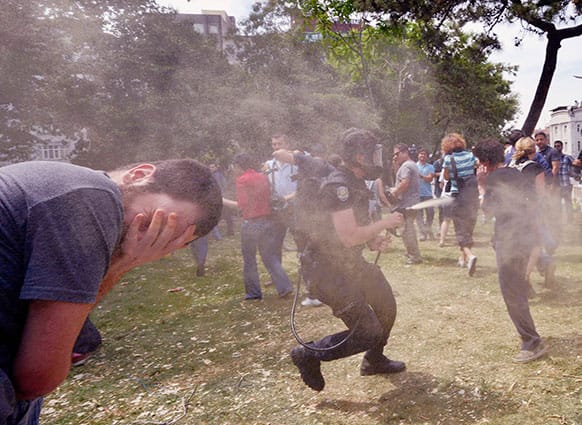 Riot police use pepper gas to disperse demonstrators protesting against the cutting down of trees in the center of Taksim Square in Istanbul, Turkey.