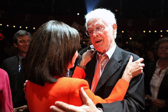 France`s former Prime Minister Lionel Jospin, right, hugs socialist candidate for the election for the mayor of Paris, Anne Hidalgo, during a meeting, in Paris.