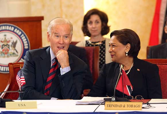 Vice President Joe Biden, left, listens to Trinidad & Tobago`s Prime Minister Kamla Persad-Bissessar during their meeting at the Diplomatic Center in St. Anns, Trinidad.