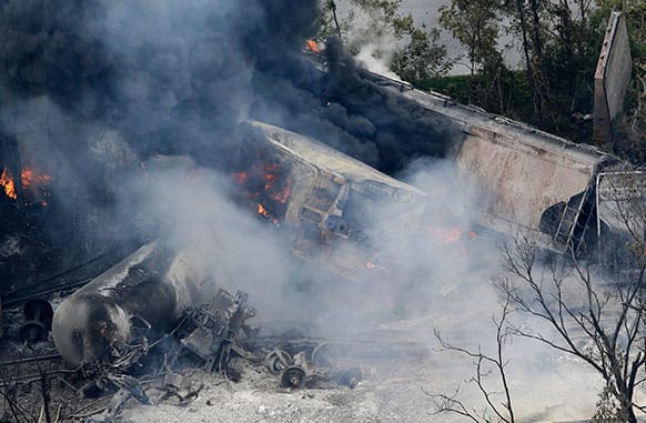 A fire burns at the site of a CSX freight train derailment in Rosedale, Md., where fire officials say the train crashed into a trash truck, causing an explosion that rattled homes at least a half-mile away and collapsed nearby buildings, setting them on fire.