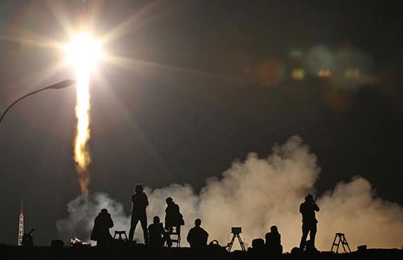 Photographers take pictures of the launch of Soyuz-FG rocket booster with Soyuz TMA-09M space ship carrying a new crew to the International Space Station, ISS, as it blasted off at the Russian leased Baikonur cosmodrome, Kazakhstan.