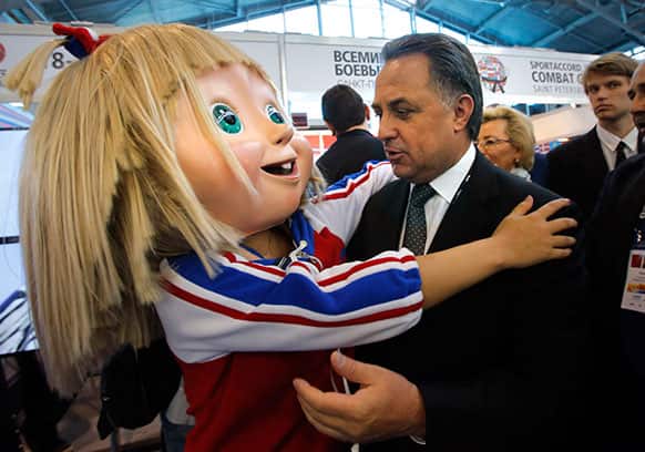 Russia`s Sports Minister Vitaly Mutko embraces a Masha mascot of 2013 Combat Games at the SportAccord International Convention in St.Petersburg, Russia.