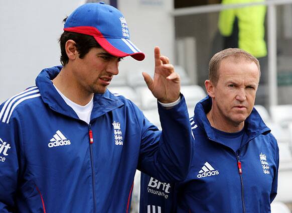 England coach Andy Flower, right, and captain Alastair Cook, left, are seen walking off the field ahead of the fifth day of the second Test match between England and New Zealand at Headingley cricket ground in Leeds, England.