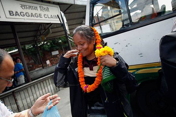 Arunima Sinha, center, is garlanded as she arrives at the airport in Katmandu, Nepal. Arunima became India’s first amputee woman on May 21, 2013 to conquer Mount Everest on a prosthetic leg.