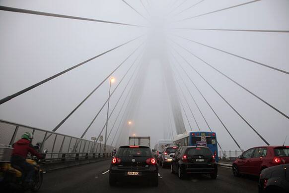 Traffic moves slowly over the ANZAC Bridge in Sydney as thick fog blankets the city Tuesday, May 28, 2013