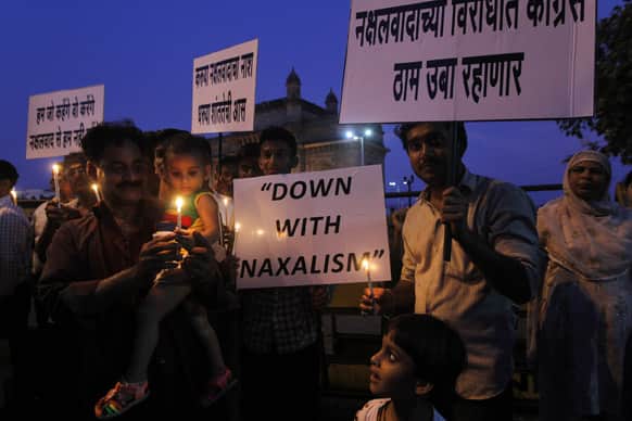India`s Congress party workers hold placards during a candle light vigil for those killed in Saturday’s Maoist attacks in Chhattisgarh state as they stand near the Gateway of India monument in Mumbai.