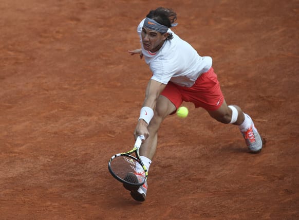 Spain`s Rafael Nadal returns against Germany`s Daniel Brands in their first round match of the French Open tennis tournament, at Roland Garros stadium in Paris.