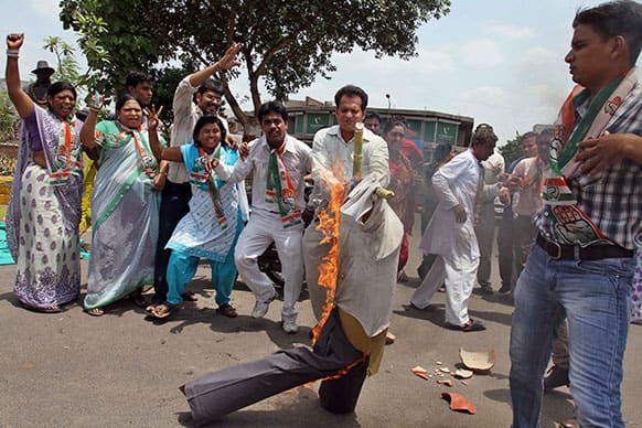 Supporters of India`s ruling Congress party burn an effigy representing Maoist rebel during a protest in Ahmadabad.