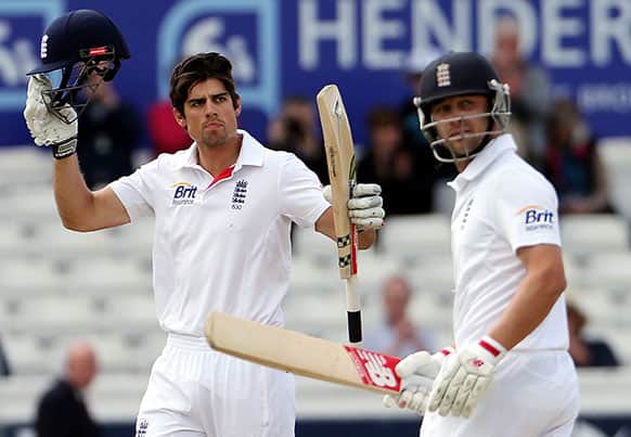England`s captain Alastair Cook, left, celebrates after scoring a century with Jonathan Trott, right, during the fourth day of the second Test match between England and New Zealand at Headingley cricket ground in Leeds.