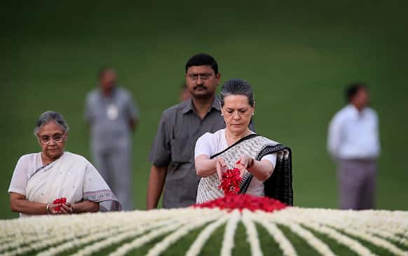 India`s ruling Congress party President Sonia Gandhi, center, and Delhi state Chief Minister Sheila Dikhsit, left, pay tribute to country’s first Prime Minister Jawaharlal Nehru on his 49th death anniversary at his memorial in New Delhi.