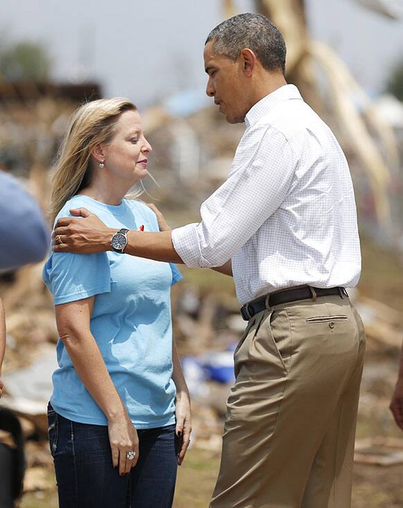 President Barack Obama talks with Plaza Towers Elementary Principal Amy Simpson outside the school in Moore, Okla. Obama visited tornado-devastated Moore, Oklahoma, consoling people staggered by the loss of life and property and promising that the government will be behind them