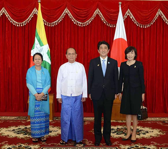 Myanmar President Thein Sein, second from left, his wife Khin Khin Win, left, Japanese Prime Minister Shinzo Abe, second from right, and his wife Akie, right, pose for photos during their meeting at the Presidential Palace in Naypyitaw, Myanmar.