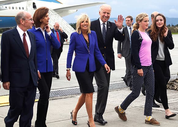 US Vice President Joe Biden, third from right, waves to reporters accompanied by his wife Jill Biden, third from left, two of their granddaughters and Colombia`s Foreign Minister Maria Angela Holguin, second from left, after their arrival to a military airport in Bogota, Colombia.