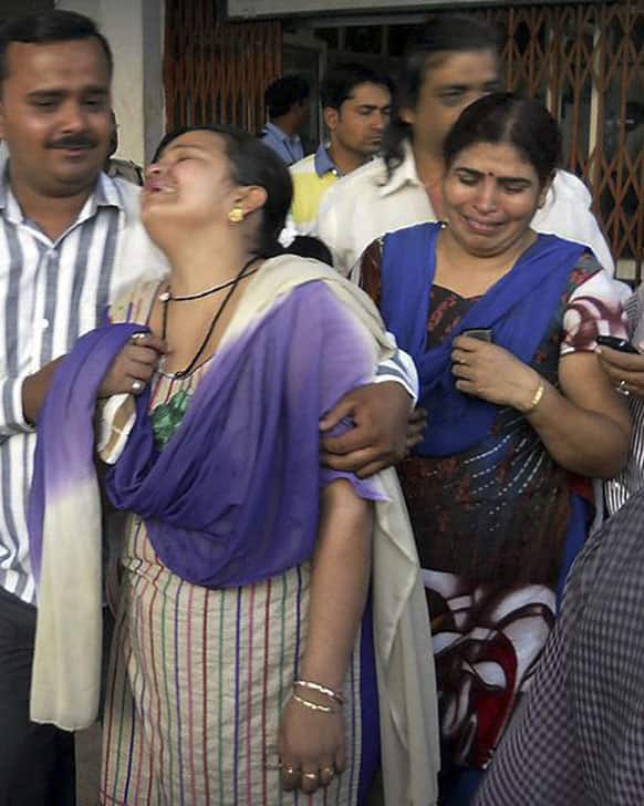 Unidentified relatives of an injured of a rebel attack cry outside a government hospital in Raipur.
