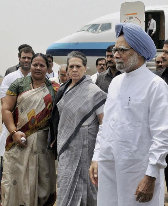 Prime Minister Manmohan Singh, Congress party President Sonia Gandhi and party Vice President Rahul Gandhi, background left, arrive at the Raipur airport following Saturday`s Maoist attack in a densely forested area, Chhattisgarh state.