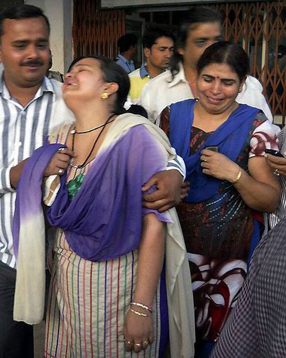 Unidentified relatives of an injured of a rebel attack cry outside a government hospital in Raipur. About 200 suspected Maoist rebels set off a land mine and opened fire on a convoy of cars carrying local leaders and supporters of Congress party, killing at least 28 people and wounding 24 others.
