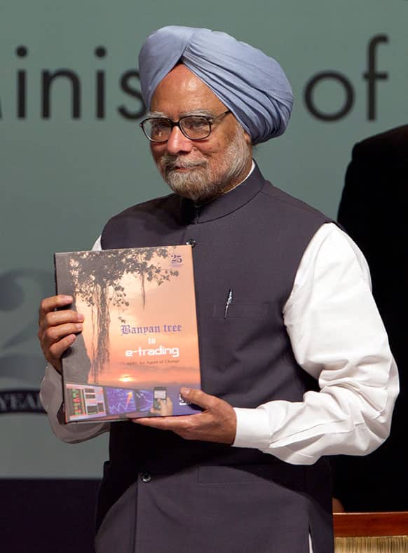 Indian Prime Minister Manmohan Singh releases a book during the Silver Jubilee celebration of Securities and Exchange Board of India, SEBI in Mumbai.