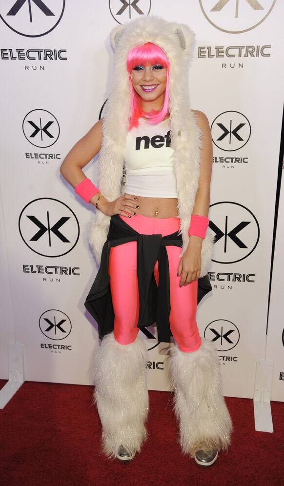 Actress Vanessa Hudgens poses before hosting the nighttime 5K run/walk Electric Run LA at the Home Depot Center, in Carson, Calif.