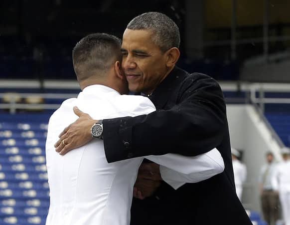 President Barack Obama embraces a member of the 2013 graduating class at the United States Naval Academy commncement ceremony in Annapolis, Md.