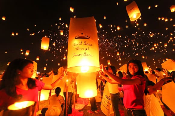 Thousands of youths release into the sky paper lanterns to celebrate