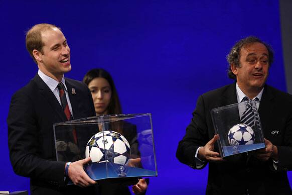 President of English Football Association Prince William, left, holding a football presented to him, reacts as UEFA President Michel Platini presents him with a mini soccer ball also after he addressed the delegates during the 37th Ordinary UEFA Congress in London.