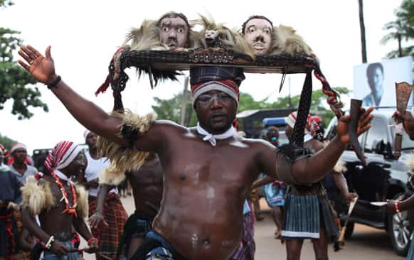 Igbo warrior dancers perform on the street during the funeral of late author Chinua Achebe, in Ogidi, Nigeria.