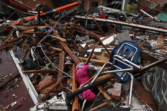 A stuffed pink unicorn is tangled amid the wreckage of Plaza Towers Elementary, where seven children were killed earlier in the week when a tornado hit Moore, Okla.