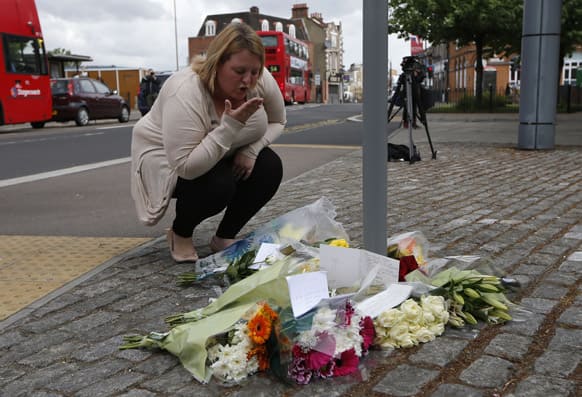 A woman blows a kiss as she lays a floral tribute in memory of the victim outside the Royal Artillery Barracks near the scene of a terror attack in Woolwich, southeast London.