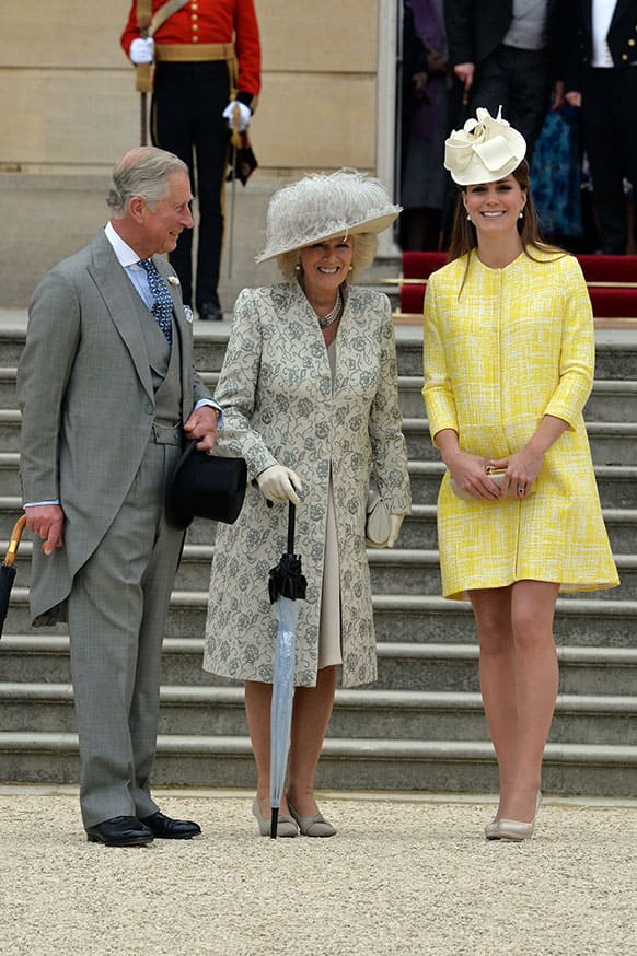 Britain`s Prince Charles, left, Camilla Duchess of Cornwall, centre, and Kate Duchess of Cambridge attend a Garden Party hosted by Queen Elizabeth II in the grounds of Buckingham Palace, central London.