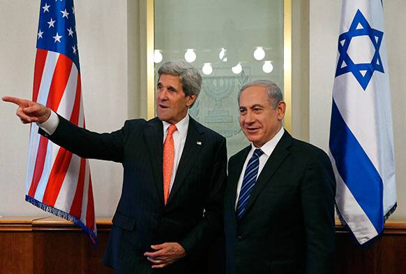 US Secretary of State John Kerry, left, gestures while meeting with Israeli Prime Minster Benjamin Netanyahu in Jerusalem.
