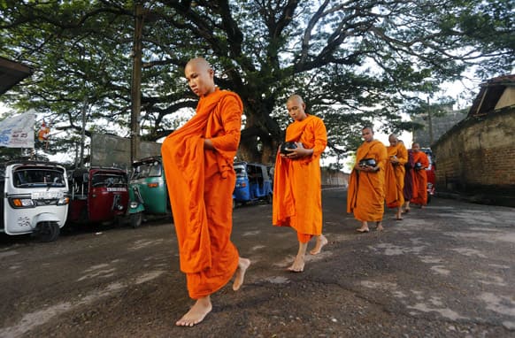 Bangladeshi Buddhists monks living in Sri Lanka parade through a street seeking alms on the eve of Vesak or Buddha Poornima in Colombo, Sri Lanka. The festival marks Buddha`s birth, enlightenment and death.