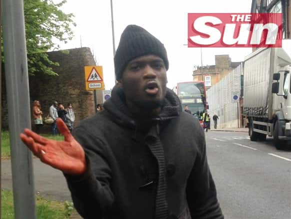 This image taken from video made available by The Sun newspaper shows what appears to be one of the attackers speaking to the camera after a brutal attack in broad daylight Wednesday, May 22, 2013 near a military barracks in London.